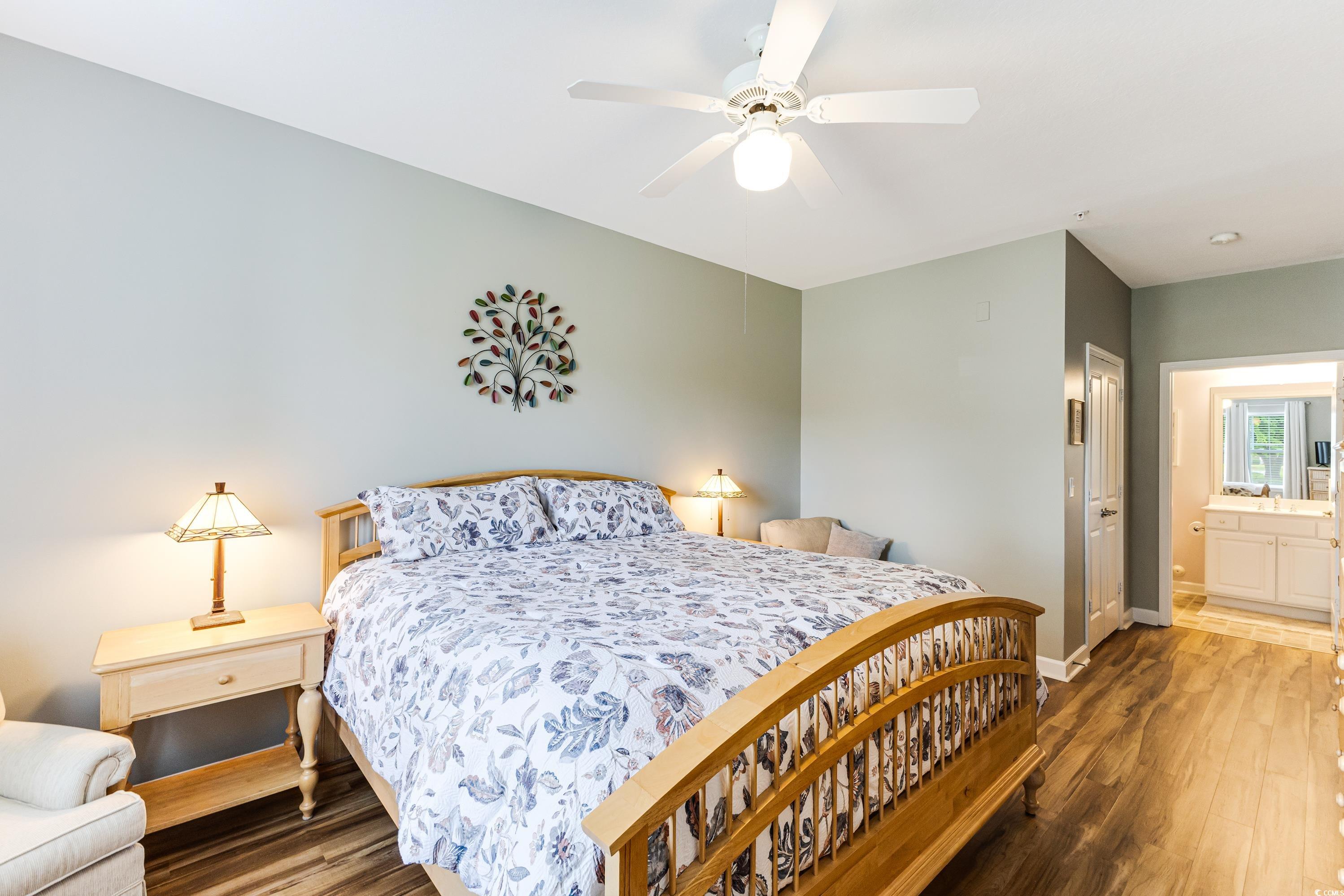 260 Woodlands Way, Unit 2 Calabash, NC 28467 - Photo 17 of 40 Bedroom featuring baseboards, wood finished floors, a ceiling fan, and ensuite bath