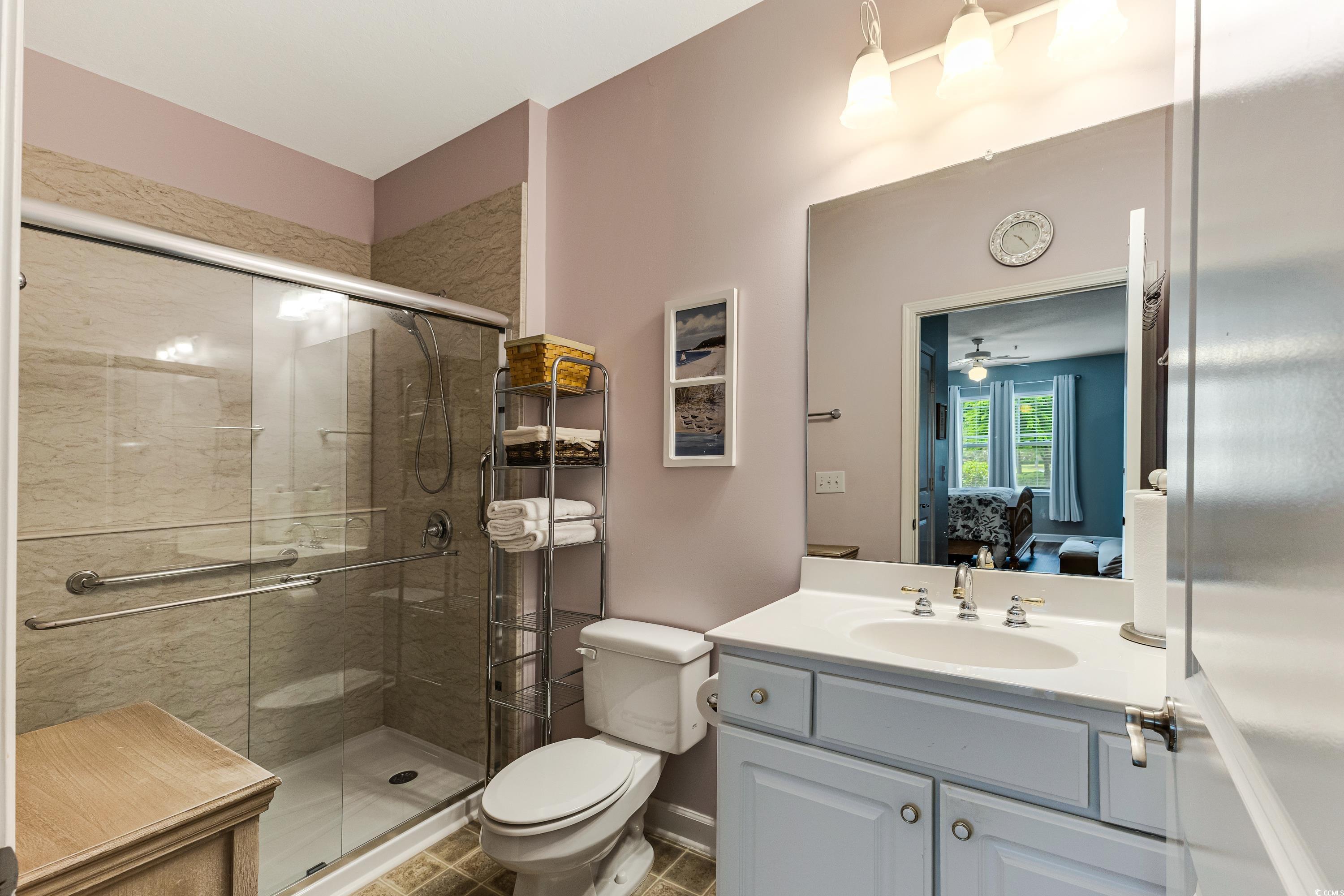 260 Woodlands Way, Unit 2 Calabash, NC 28467 - Photo 18 of 40 Ensuite bathroom featuring a stall shower, toilet, vanity, and a ceiling fan