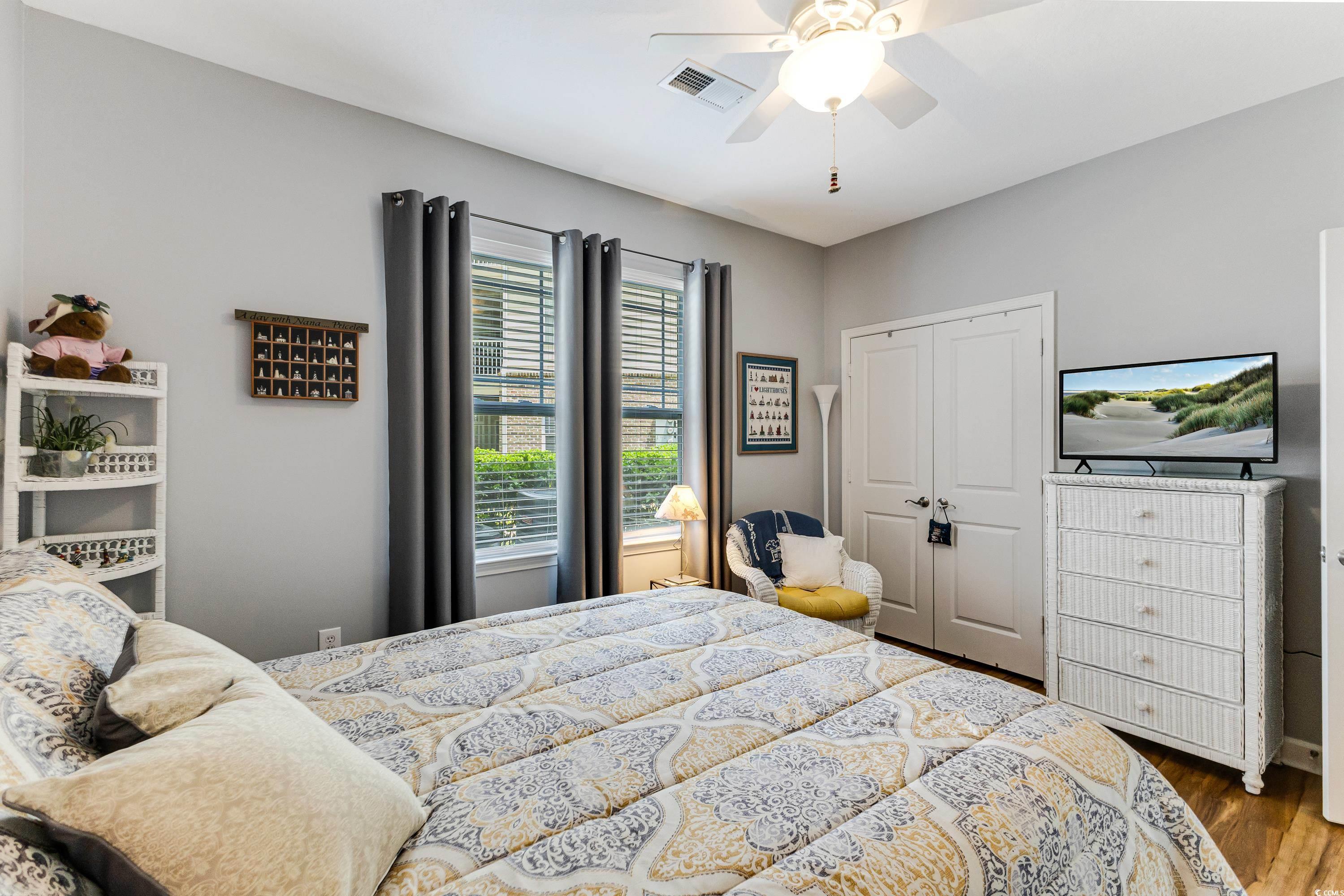 260 Woodlands Way, Unit 2 Calabash, NC 28467 - Photo 20 of 40 Bedroom featuring wood finished floors, a closet, and a ceiling fan