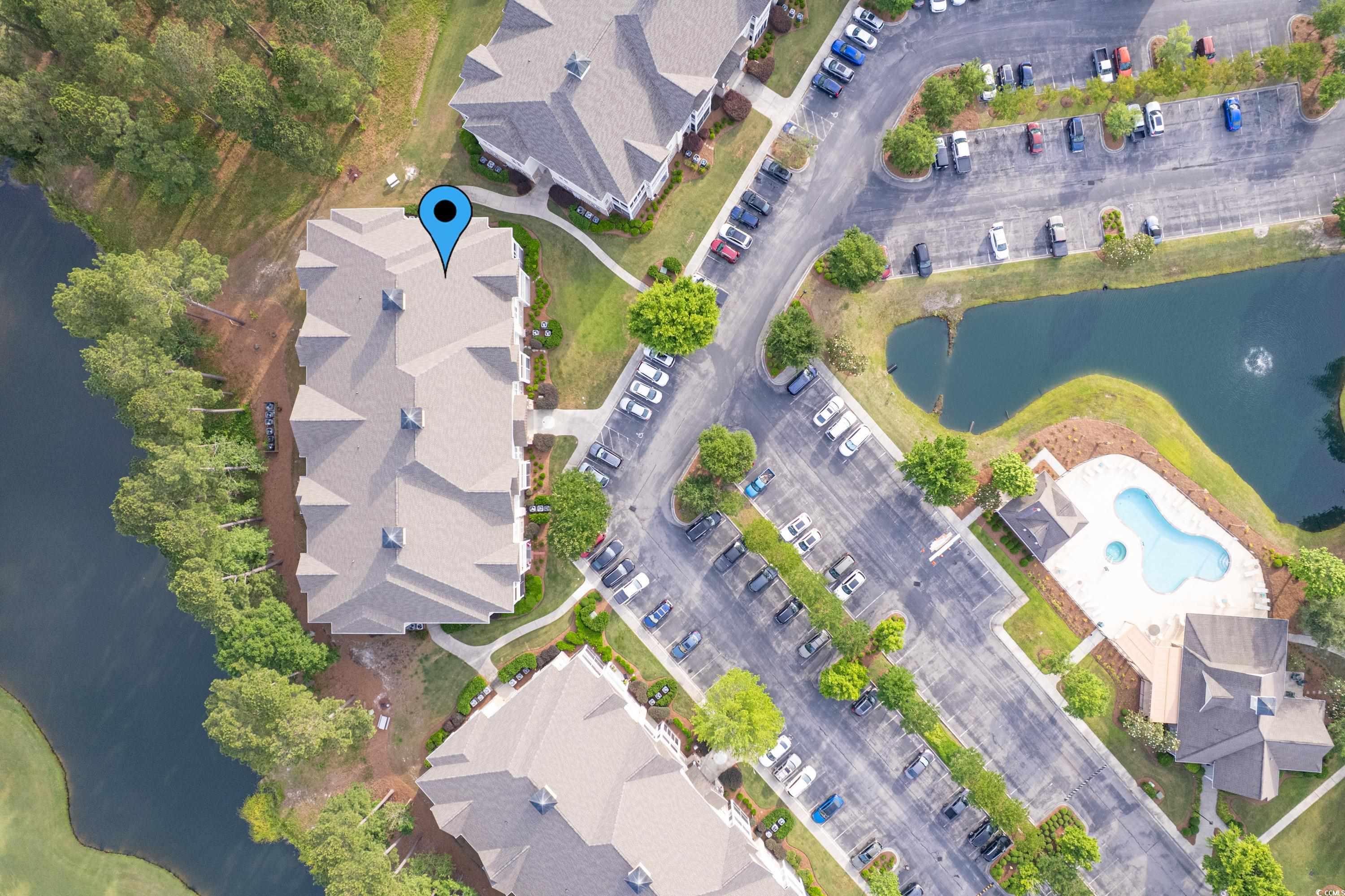 260 Woodlands Way, Unit 2 Calabash, NC 28467 - Photo 29 of 40 Aerial view of property's location with a large body of water and a pool