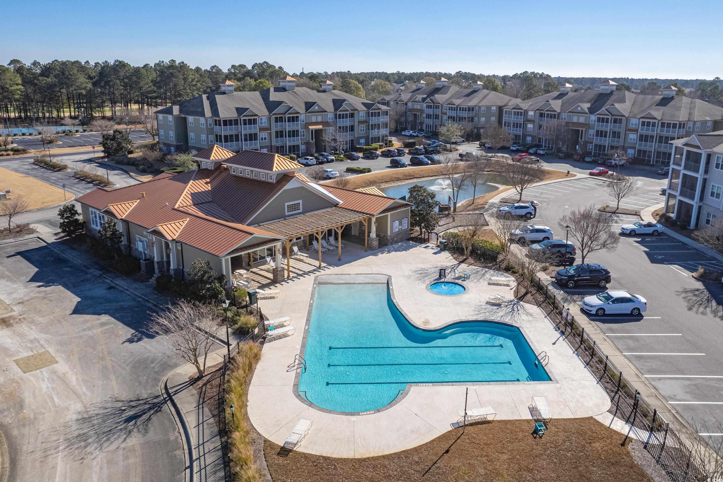 260 Woodlands Way, Unit 2 Calabash, NC 28467 - Photo 30 of 40 Community pool featuring a patio, fence, and a residential view
