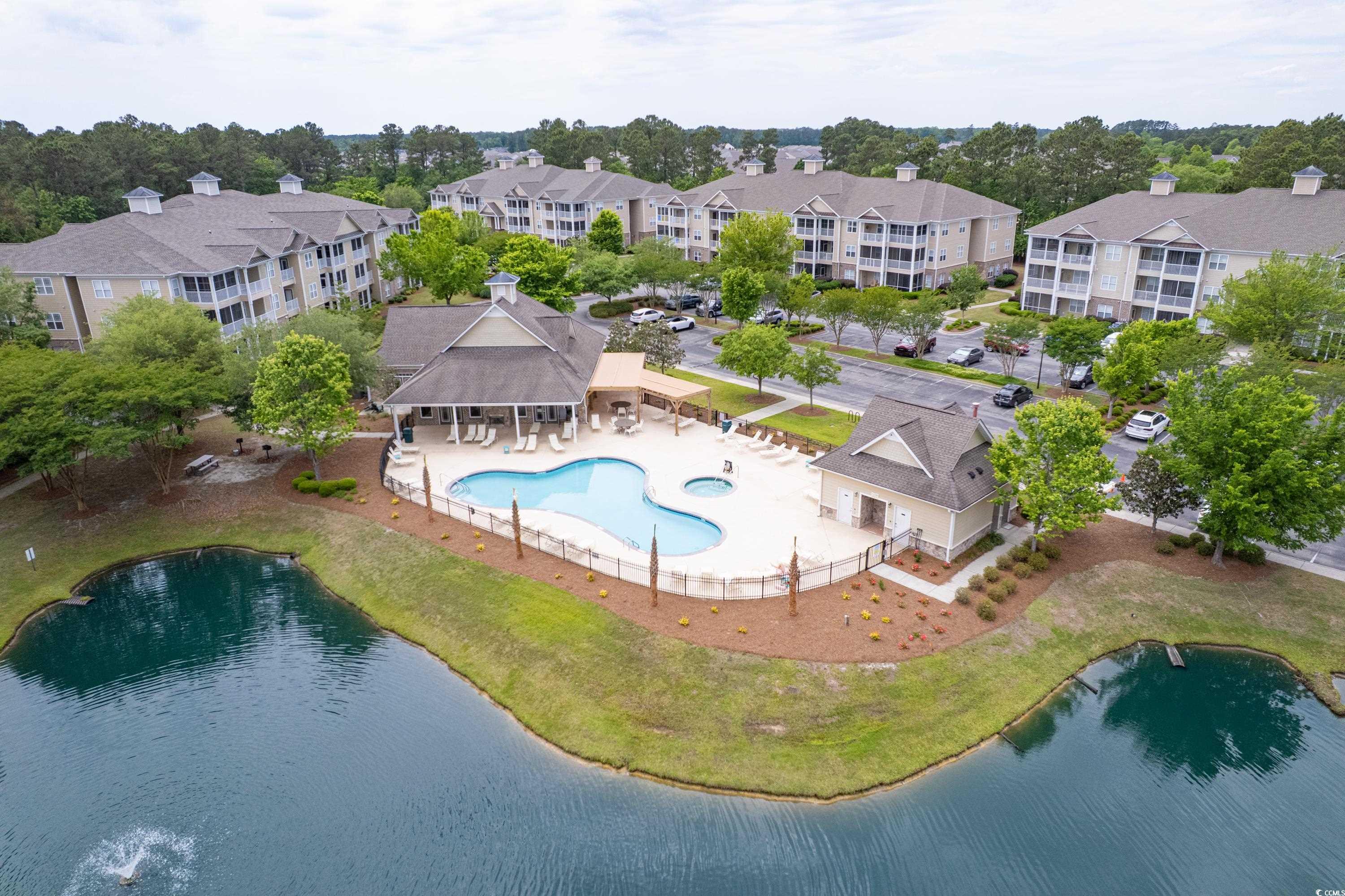 260 Woodlands Way, Unit 2 Calabash, NC 28467 - Photo 31 of 40 Bird's eye view of a pool and a large body of water