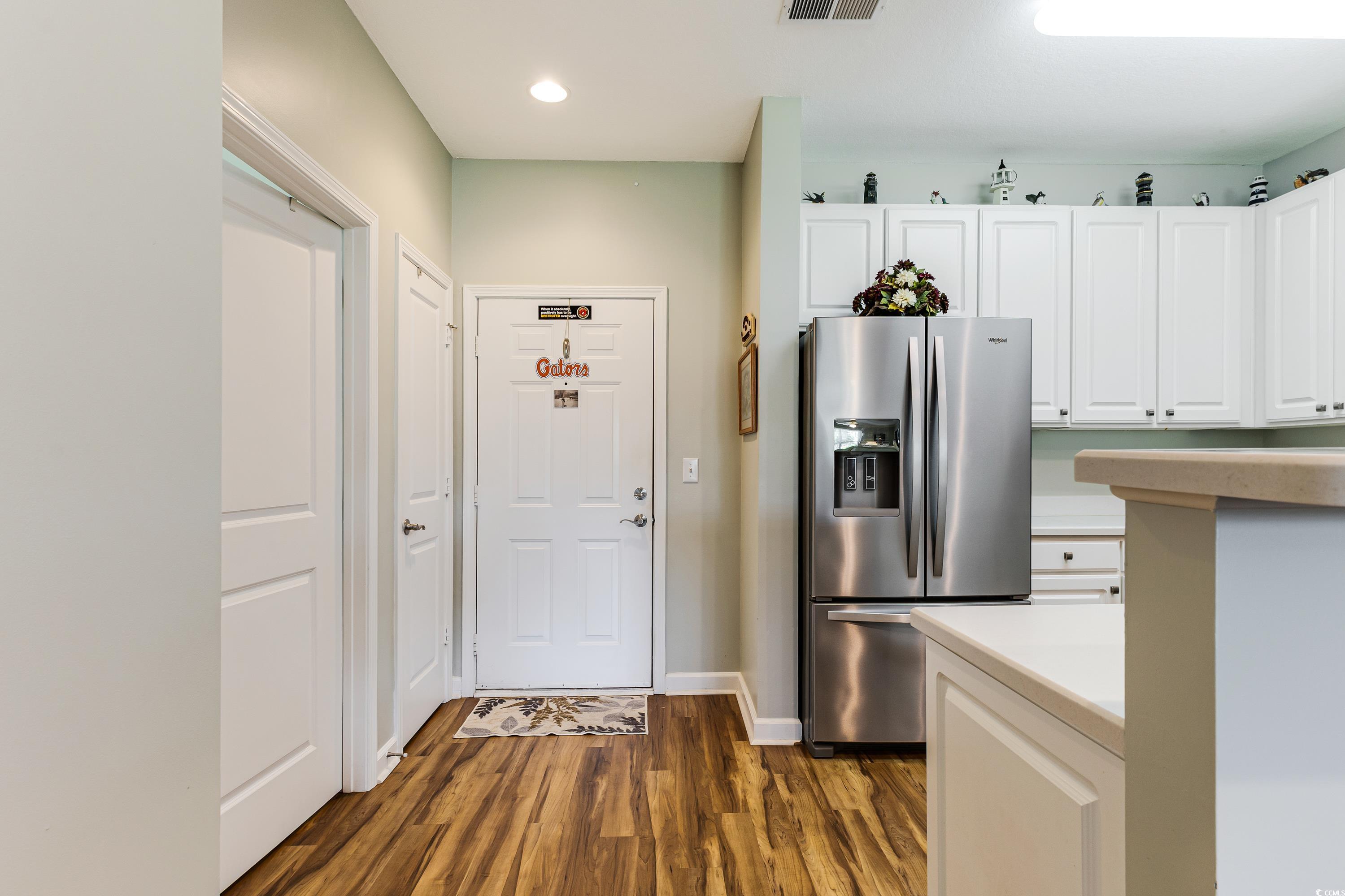 260 Woodlands Way, Unit 2 Calabash, NC 28467 - Photo 4 of 40 Kitchen featuring stainless steel fridge with ice dispenser, dark wood-style floors, white cabinetry, recessed lighting, and light countertops