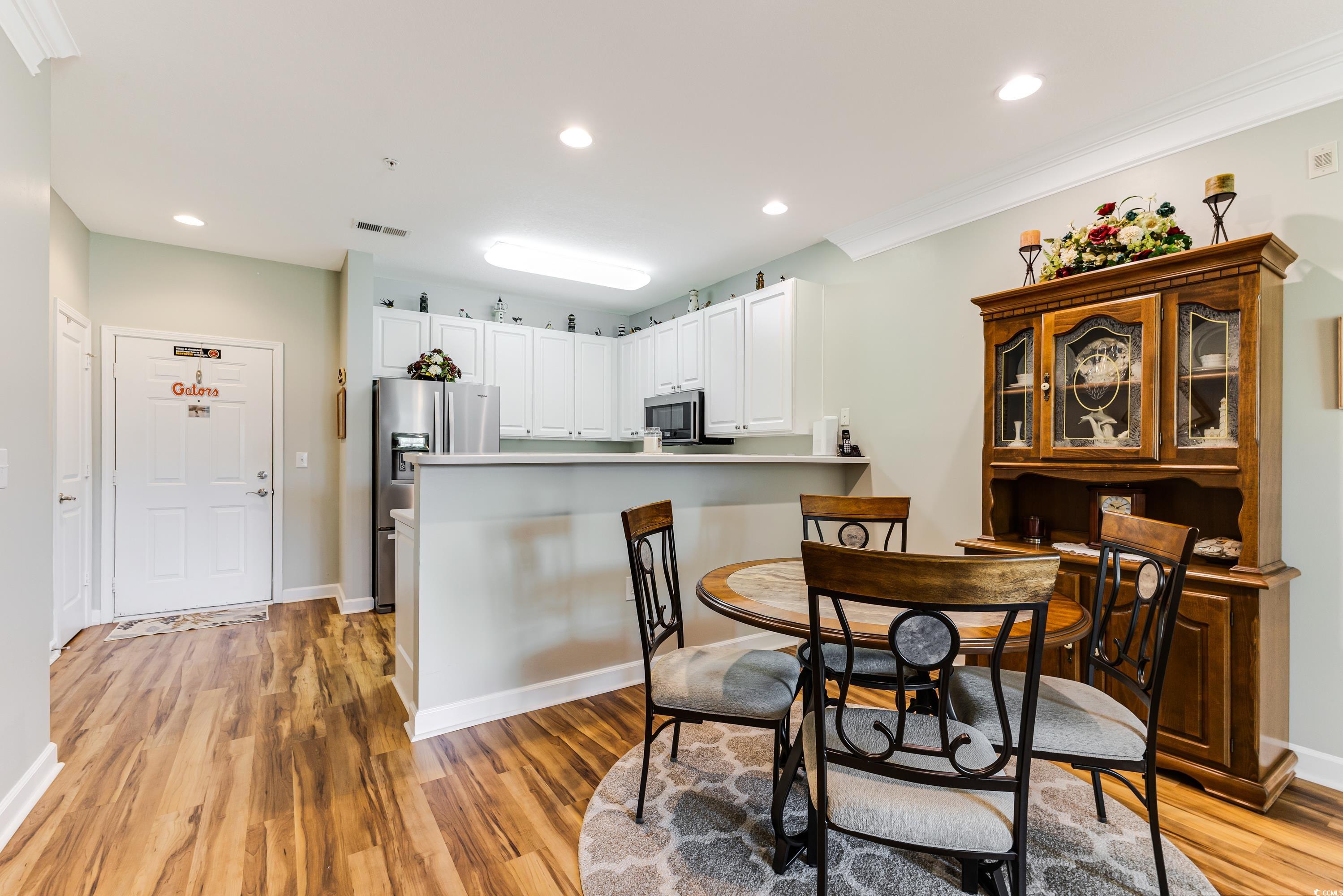 260 Woodlands Way, Unit 2 Calabash, NC 28467 - Photo 8 of 40 Dining room with light wood-style flooring, recessed lighting, crown molding, and baseboards