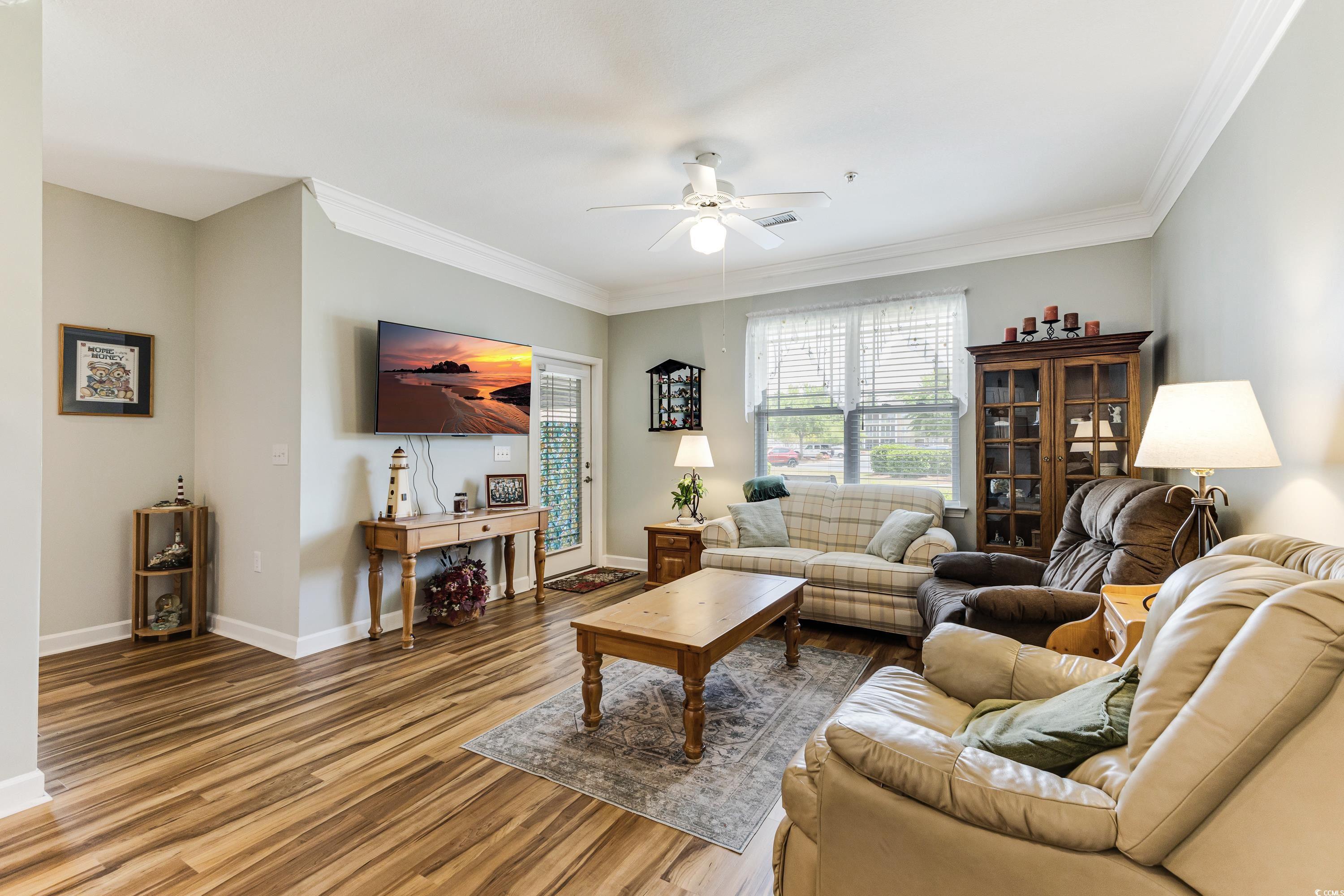 260 Woodlands Way, Unit 2 Calabash, NC 28467 - Photo 10 of 40 Living room with a ceiling fan, wood finished floors, crown molding, and baseboards