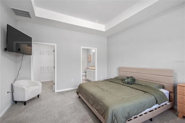 a bathroom with a granite countertop sink a toilet and a large mirror