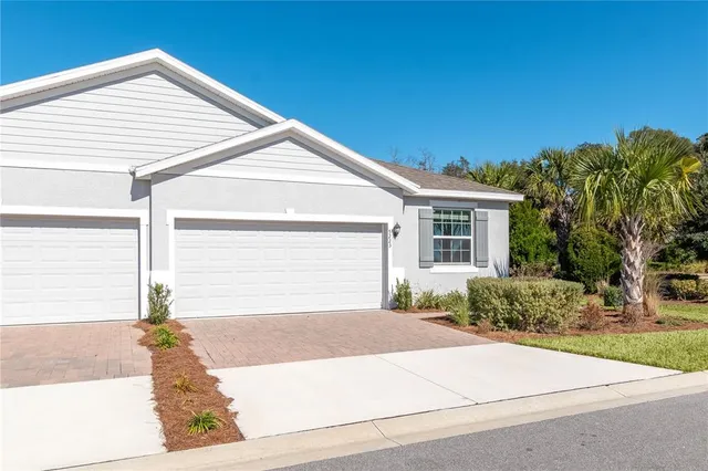 a front view of a house with a yard and a garage