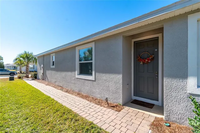a view of a patio with table and chairs and potted plants