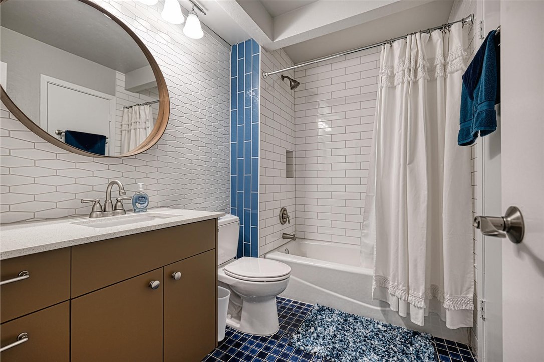 1748 Ohlen Road, Unit 74 Austin, TX 78757 - Photo 12 of 15 a bathroom with a sink toilet and shower