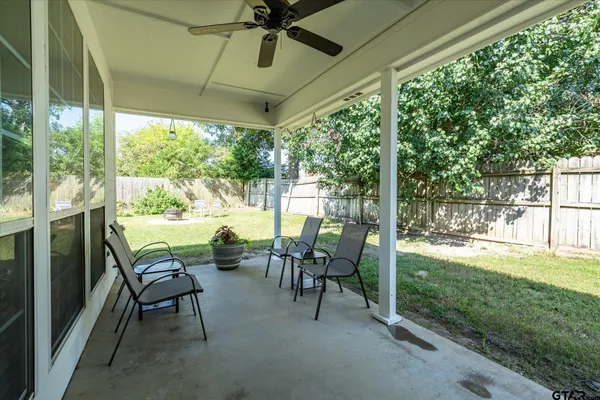 a view of a porch with chairs and backyard