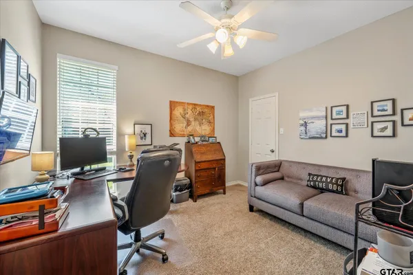 a view of a livingroom with workspace and a couch