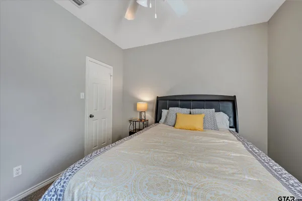 a bedroom with a bed and a night stand