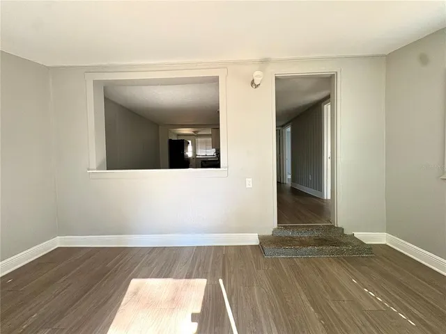 a view of a room with wooden floor and staircase