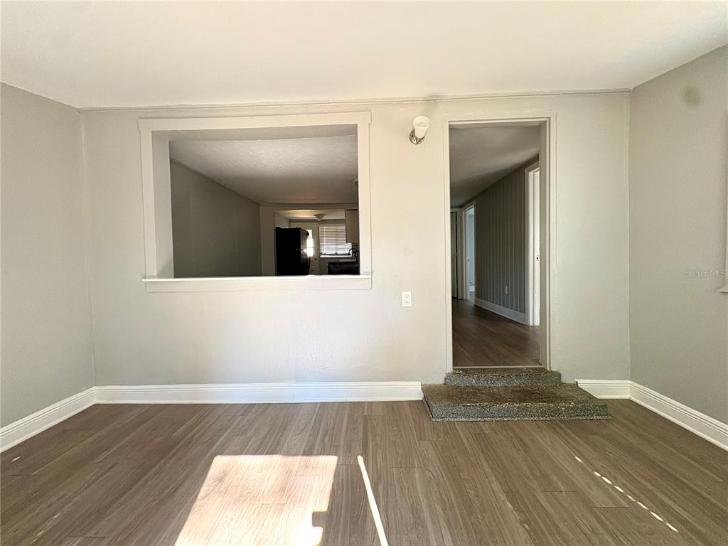 4611 North Hubert Avenue, Unit 11 Tampa, FL 33614 - Photo 2 of 10 a view of a room with wooden floor and staircase