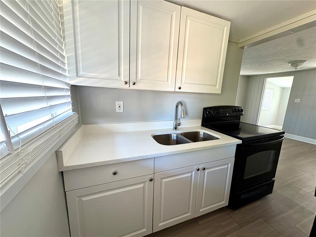 4611 North Hubert Avenue, Unit 11 Tampa, FL 33614 - Photo 7 of 10 a kitchen with white cabinets a sink and dishwasher