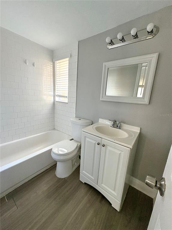 4611 North Hubert Avenue, Unit 11 Tampa, FL 33614 - Photo 9 of 10 a bathroom with a toilet sink and mirror