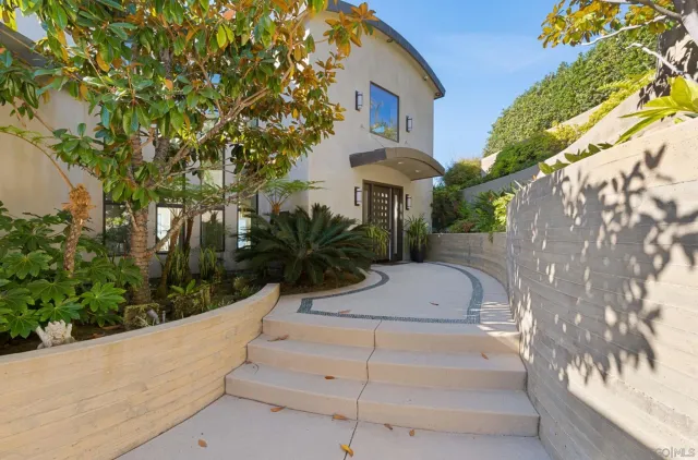 a view of house with outdoor space and sitting area