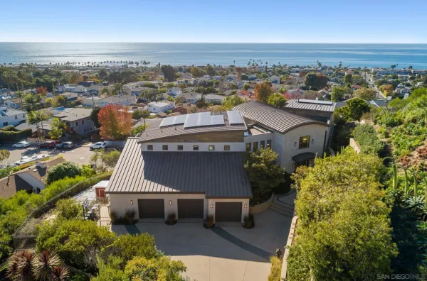 an aerial view of a house with a yard lake view