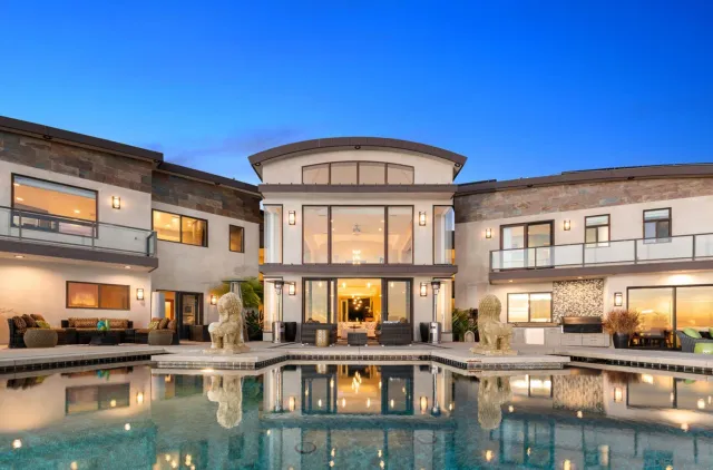 a view of a building with swimming pool and sitting area