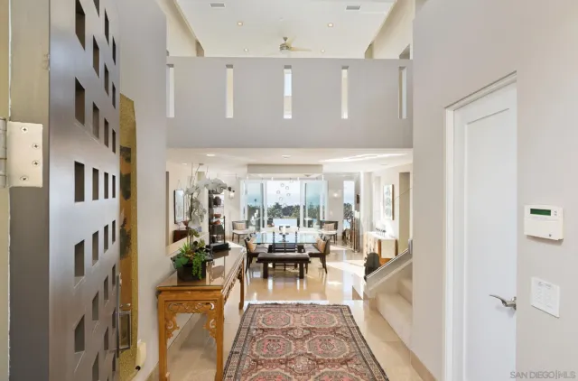 a living room with fireplace furniture and a large window