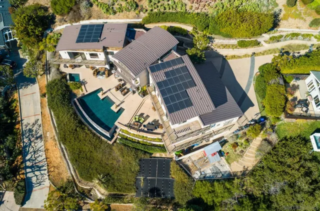 an aerial view of a house with a garden and swimming pool