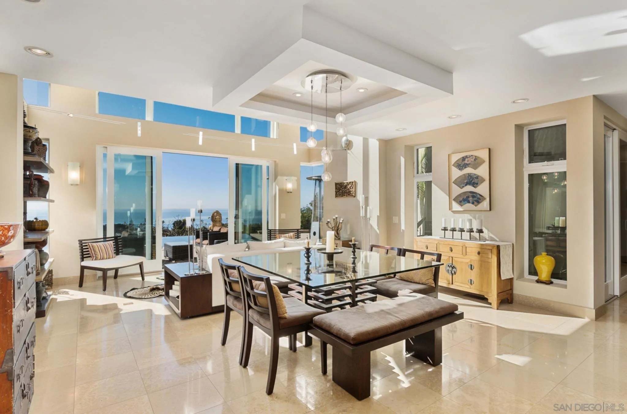 5680 Linda Rosa Avenue La Jolla, CA 92037 - Photo 9 of 24 a dining hall with couches a dining table and chairs with wooden floor
