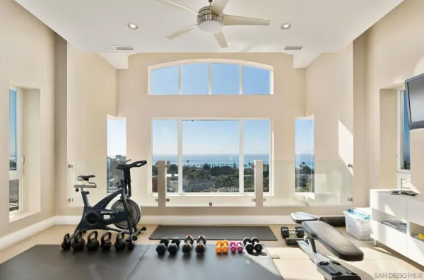 a living room with furniture and large windows