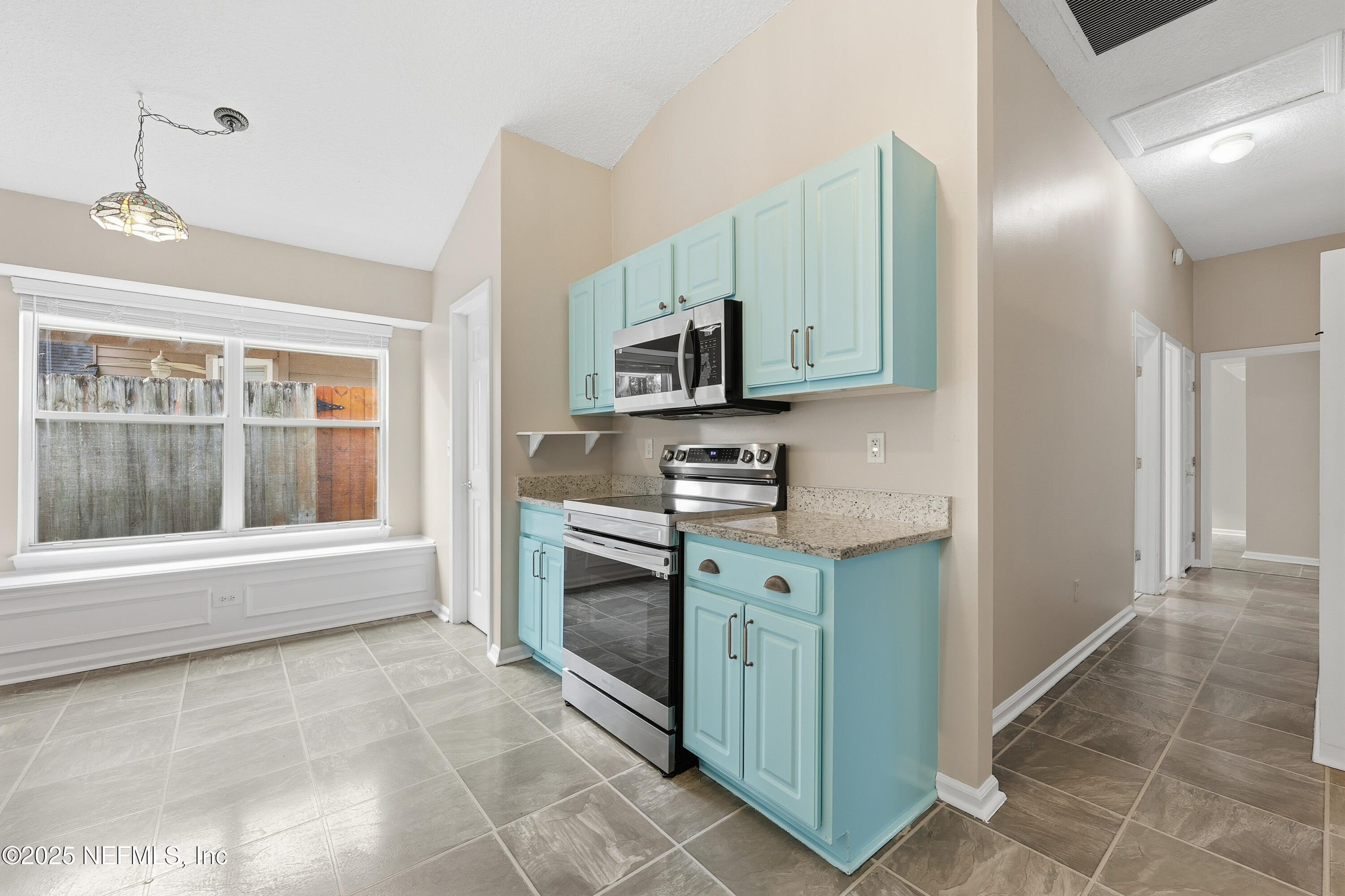 1655 Highland View Court Fleming Island, FL 32003 - Photo 16 of 56 a kitchen with stainless steel appliances granite countertop a stove a microwave and a refrigerator