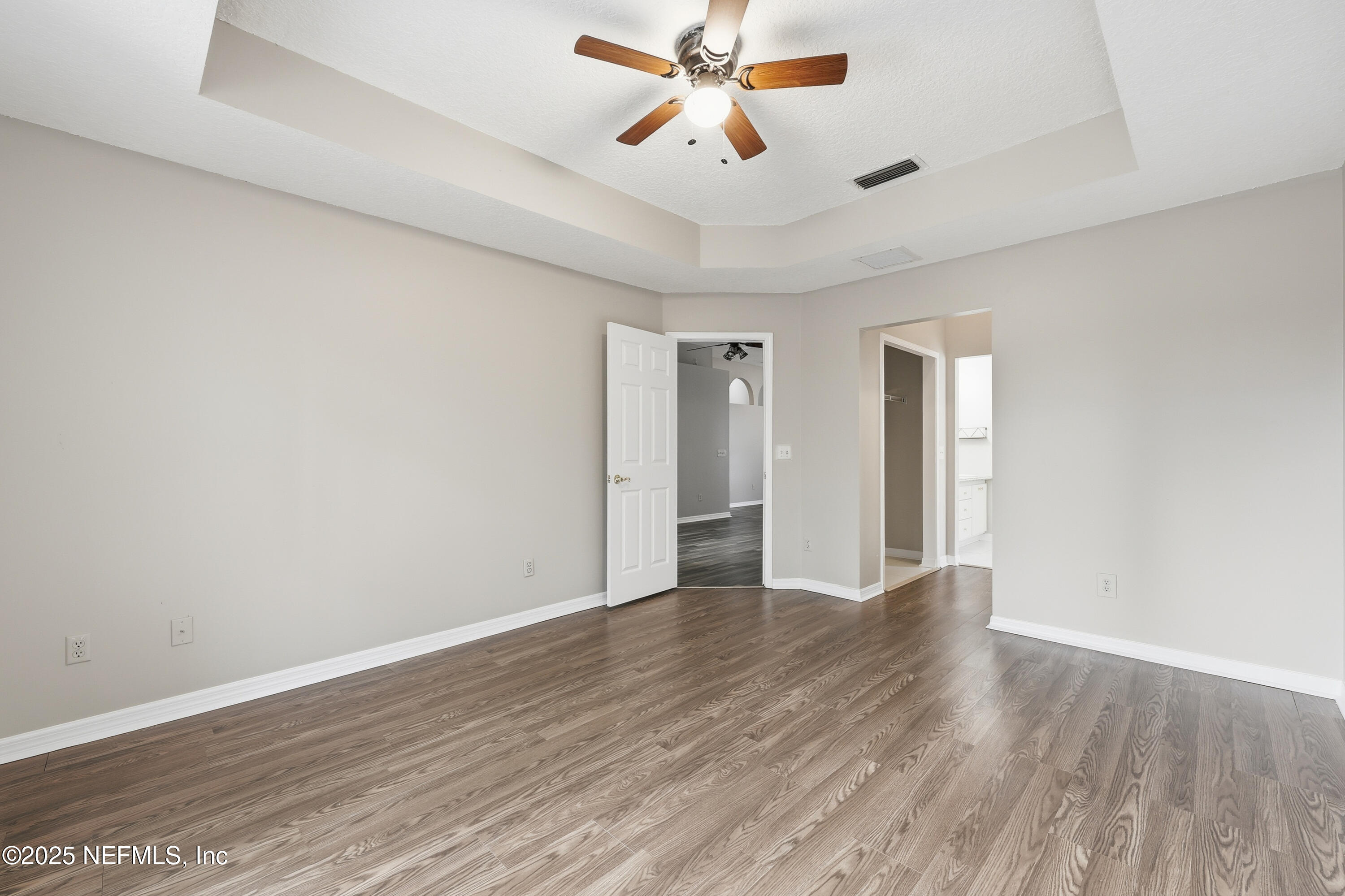 1655 Highland View Court Fleming Island, FL 32003 - Photo 22 of 56 an empty room with wooden floor and windows