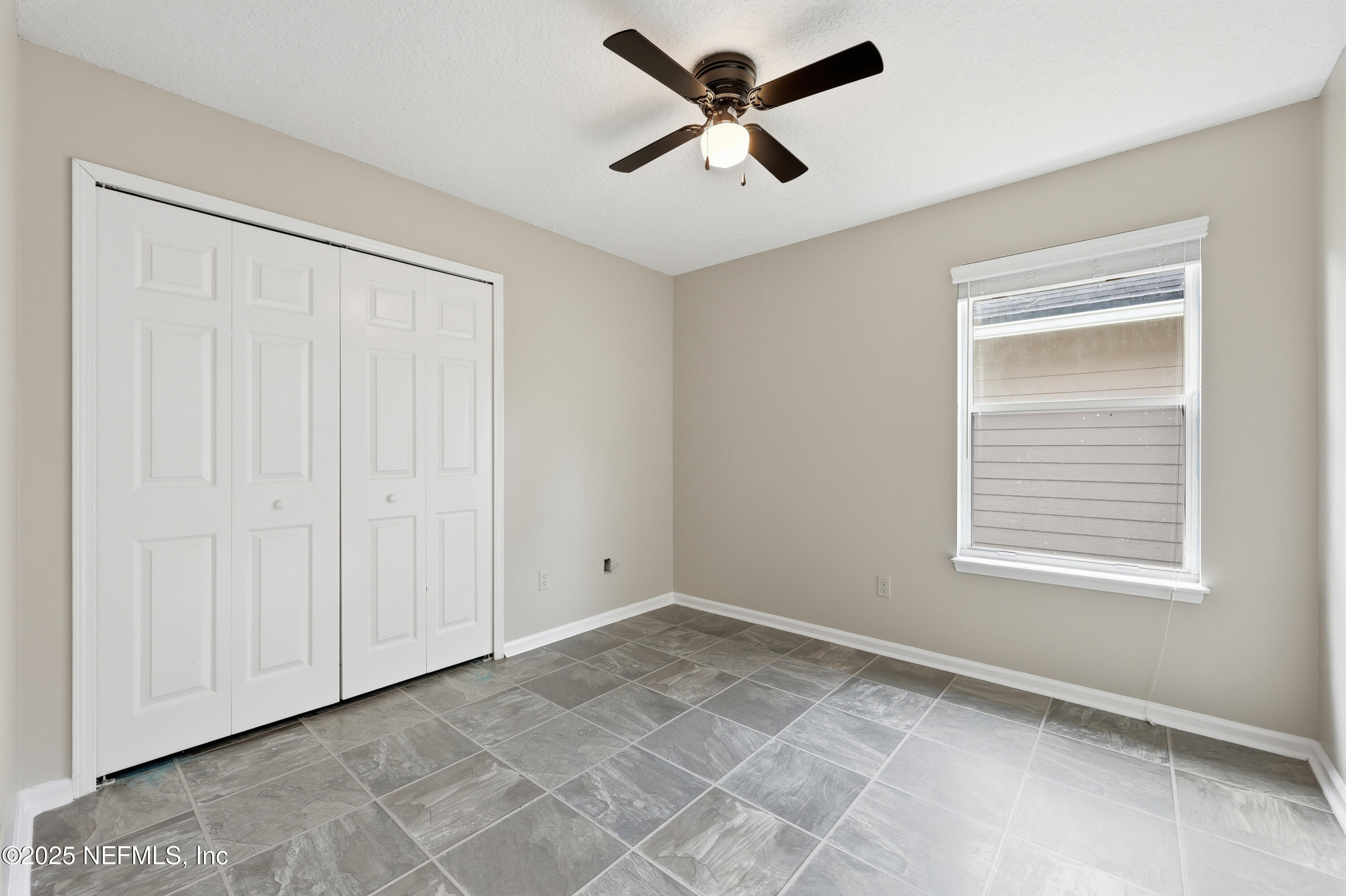 1655 Highland View Court Fleming Island, FL 32003 - Photo 29 of 56 a view of a livingroom with a ceiling fan and window