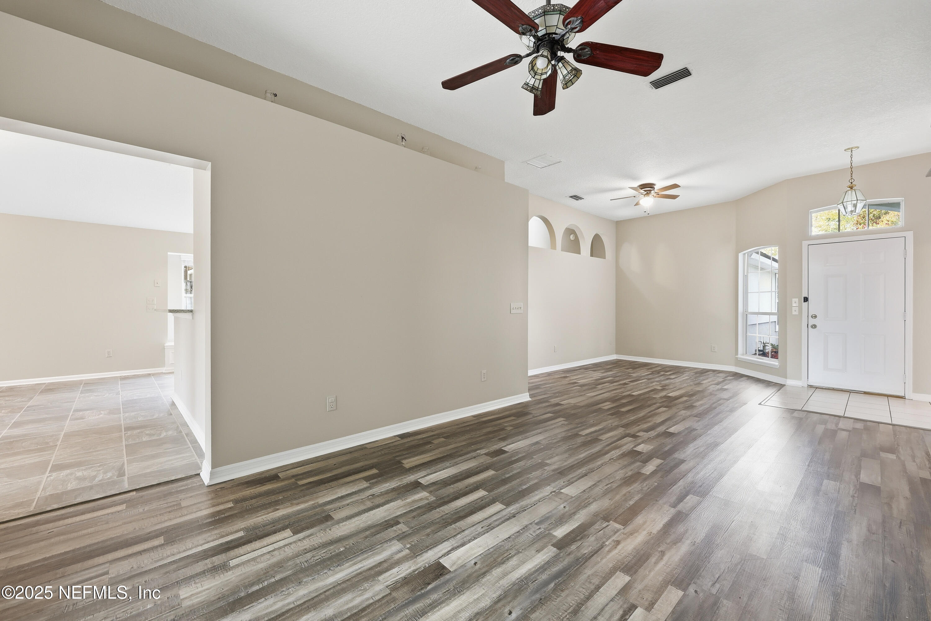 1655 Highland View Court Fleming Island, FL 32003 - Photo 8 of 56 a view of an empty room and window and wooden floor