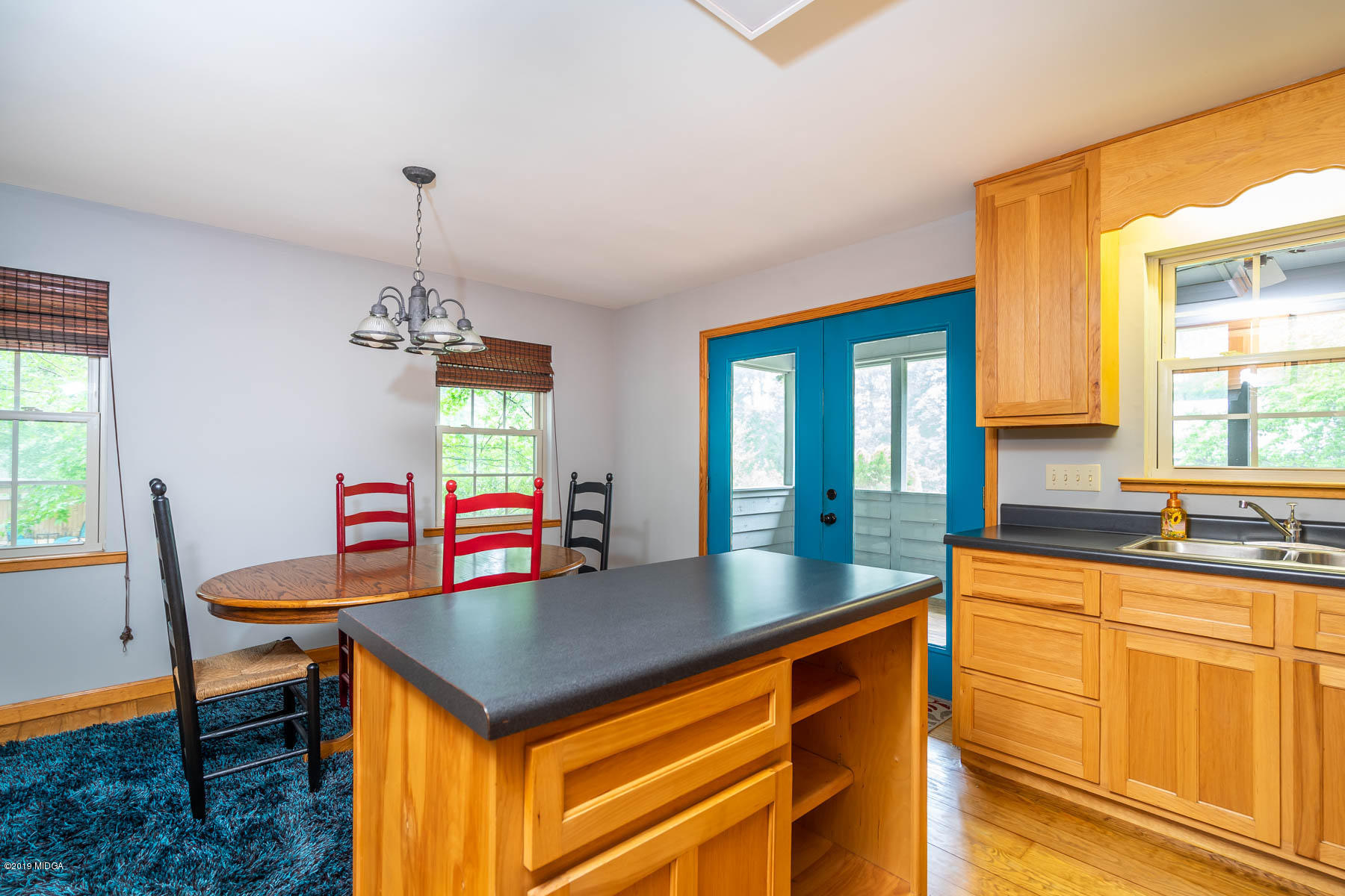 5934 Dames Ferry Road Juliette, GA 31046 - Photo 13 of 41 a kitchen that has a cabinets counter space dining table and a chandelier