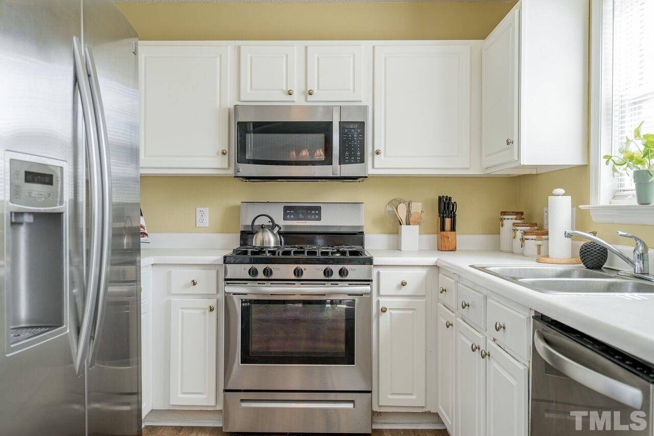 4428 Moss Spring Drive Raleigh, NC 27616 - Photo 13 of 27 a kitchen with cabinets stainless steel appliances and a sink