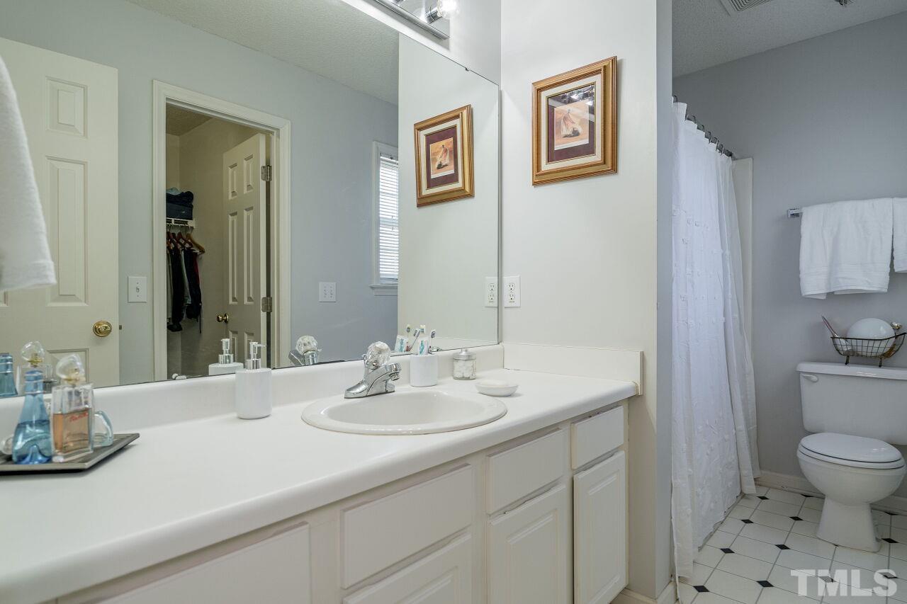 4428 Moss Spring Drive Raleigh, NC 27616 - Photo 18 of 27 a bathroom with a sink a toilet and a mirror
