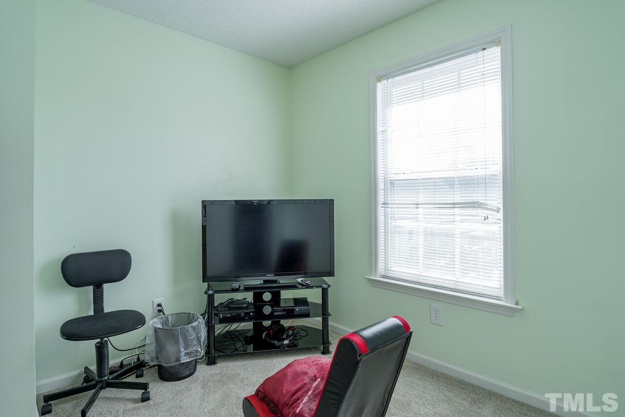 4428 Moss Spring Drive Raleigh, NC 27616 - Photo 19 of 27 a living room with furniture and a flat screen tv