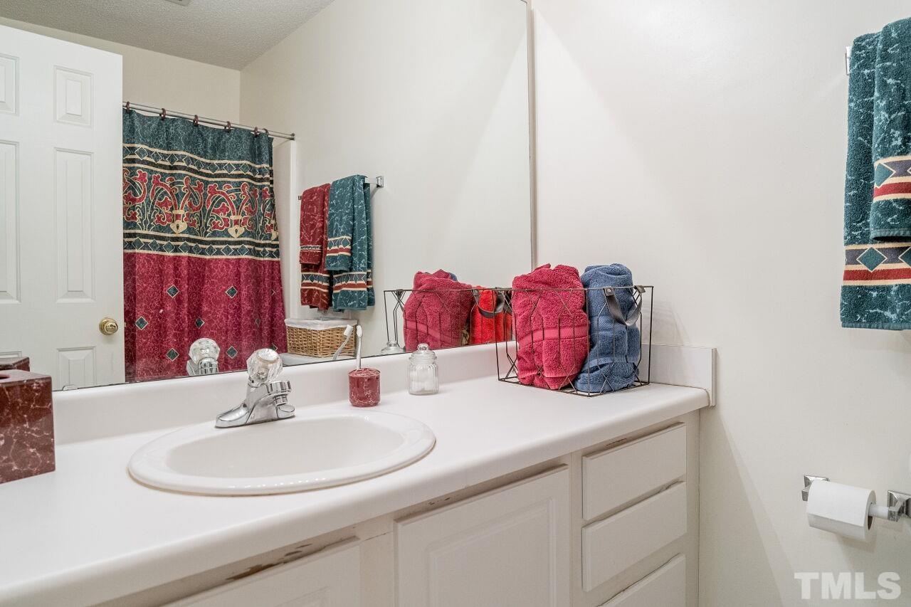 4428 Moss Spring Drive Raleigh, NC 27616 - Photo 20 of 27 a bathroom with a sink and a mirror