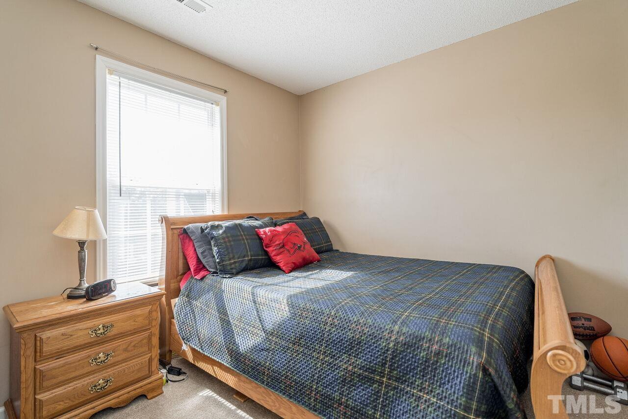 4428 Moss Spring Drive Raleigh, NC 27616 - Photo 21 of 27 a bedroom with a bed and a window