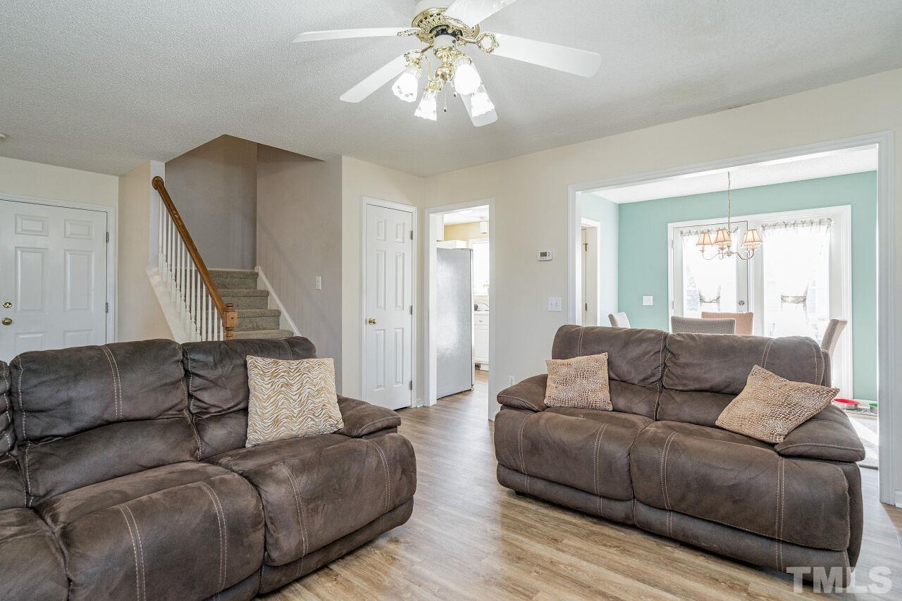 4428 Moss Spring Drive Raleigh, NC 27616 - Photo 7 of 27 a living room with furniture and a chandelier