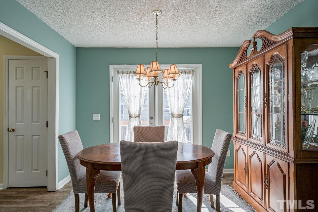 4428 Moss Spring Drive Raleigh, NC 27616 - Photo 9 of 27 a view of a dining room with furniture window and wooden floor