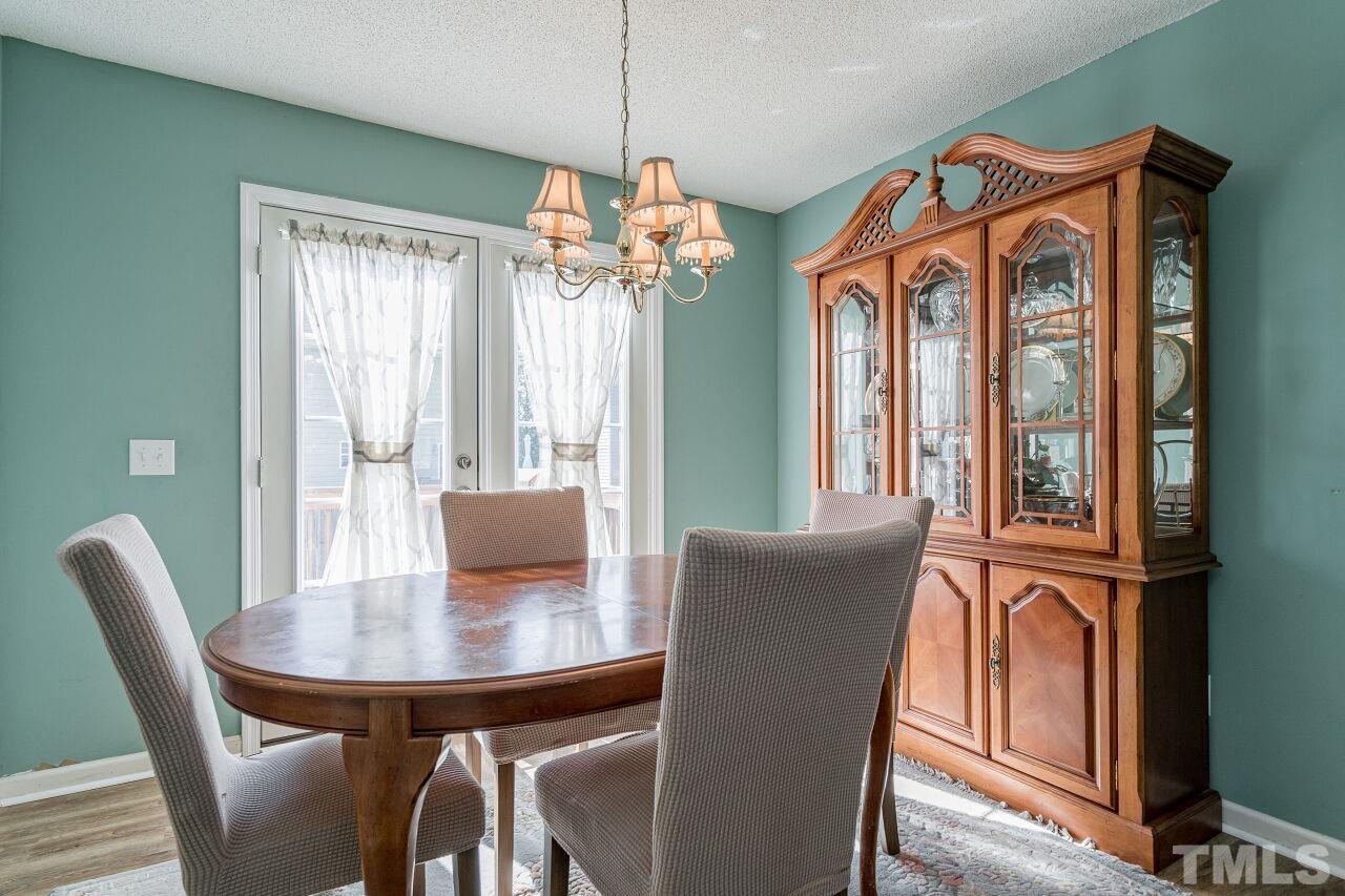 4428 Moss Spring Drive Raleigh, NC 27616 - Photo 10 of 27 a view of a dining room with furniture window and outside view