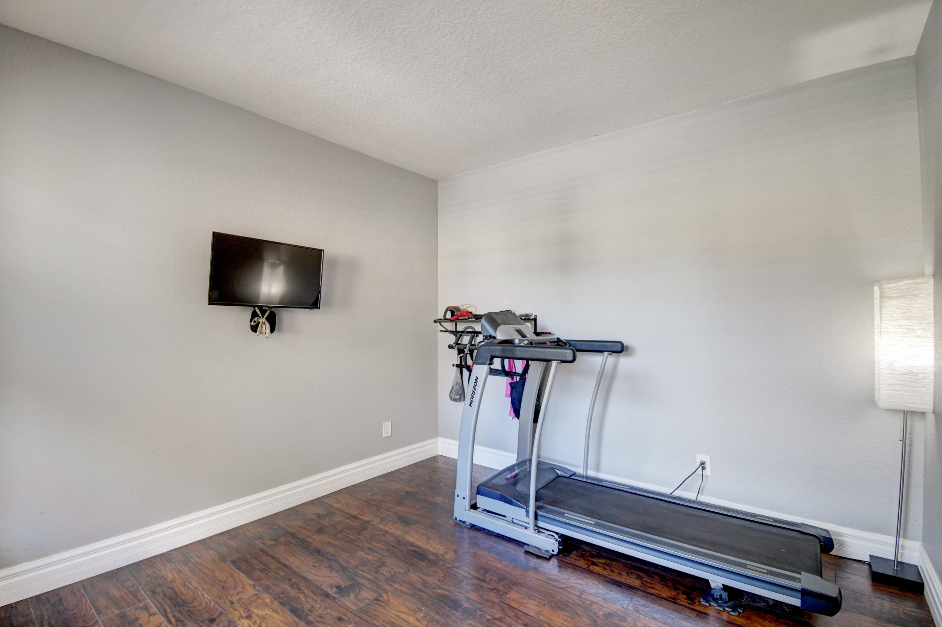 804 Quartz Terrace West Palm Beach, FL 33413 - Photo 12 of 65 a room with gym equipment and a flat screen tv