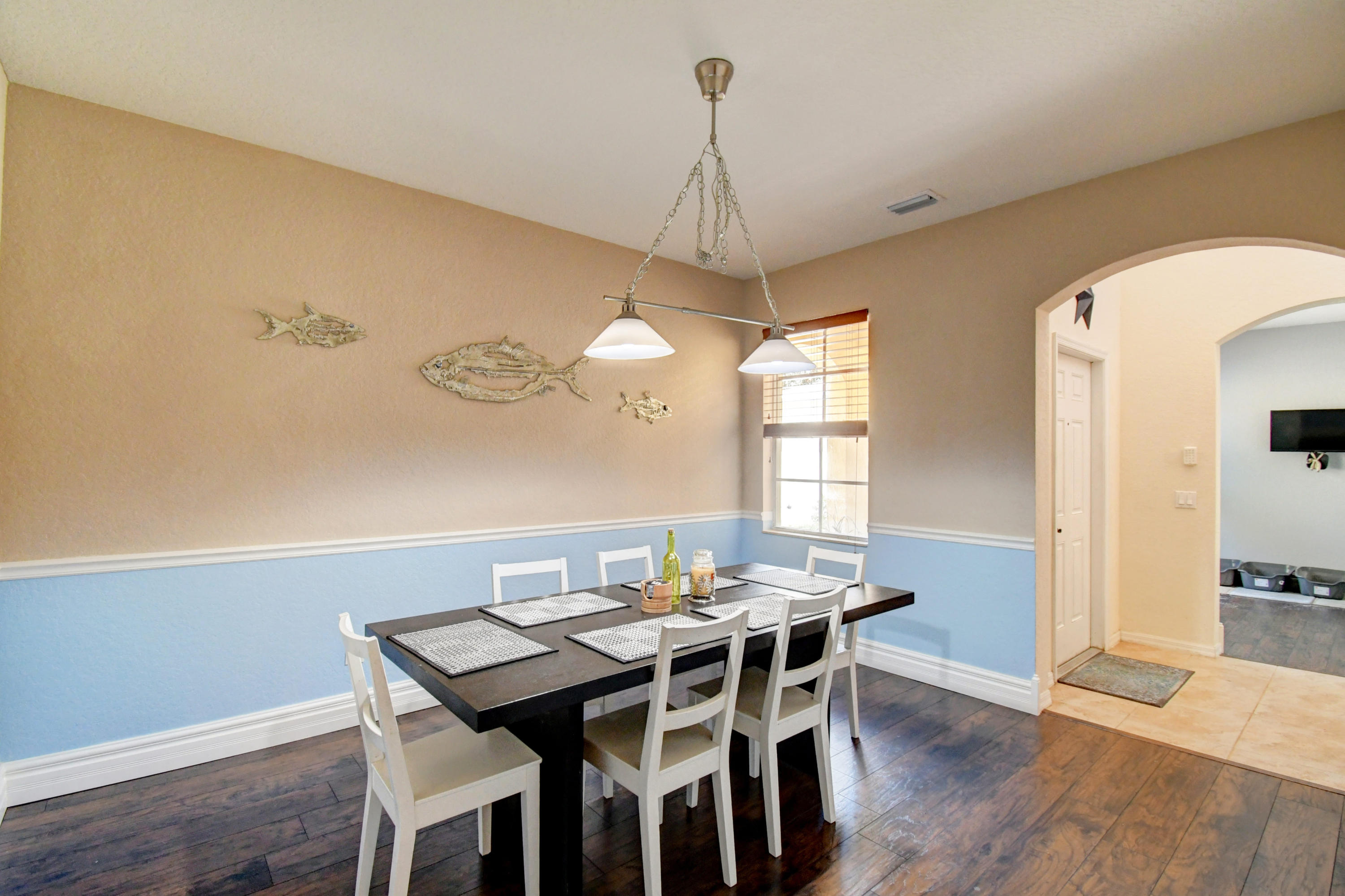 804 Quartz Terrace West Palm Beach, FL 33413 - Photo 15 of 65 a view of a dining room with furniture window and wooden floor