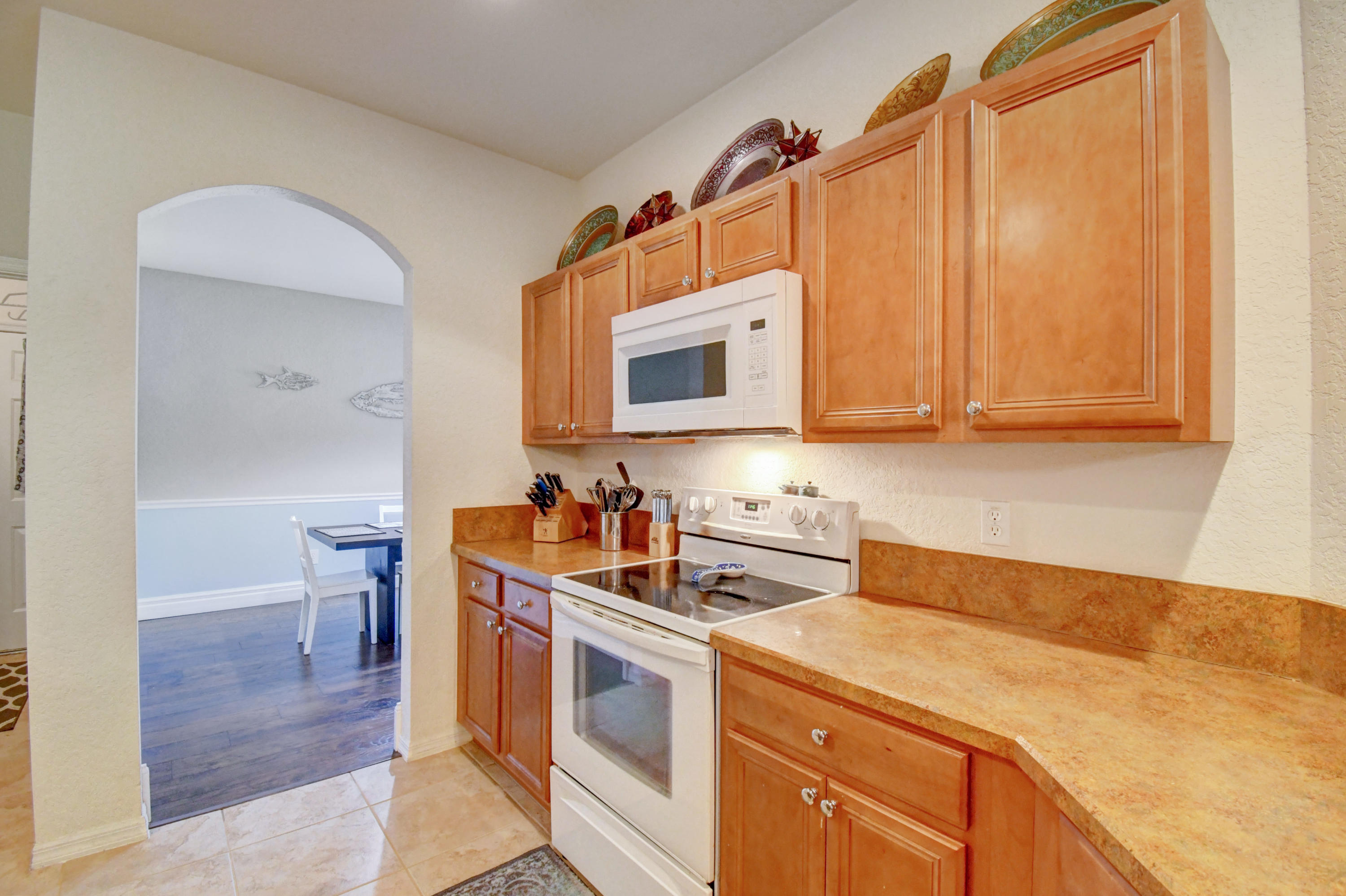 804 Quartz Terrace West Palm Beach, FL 33413 - Photo 17 of 65 a kitchen with stainless steel appliances a stove a microwave and cabinets