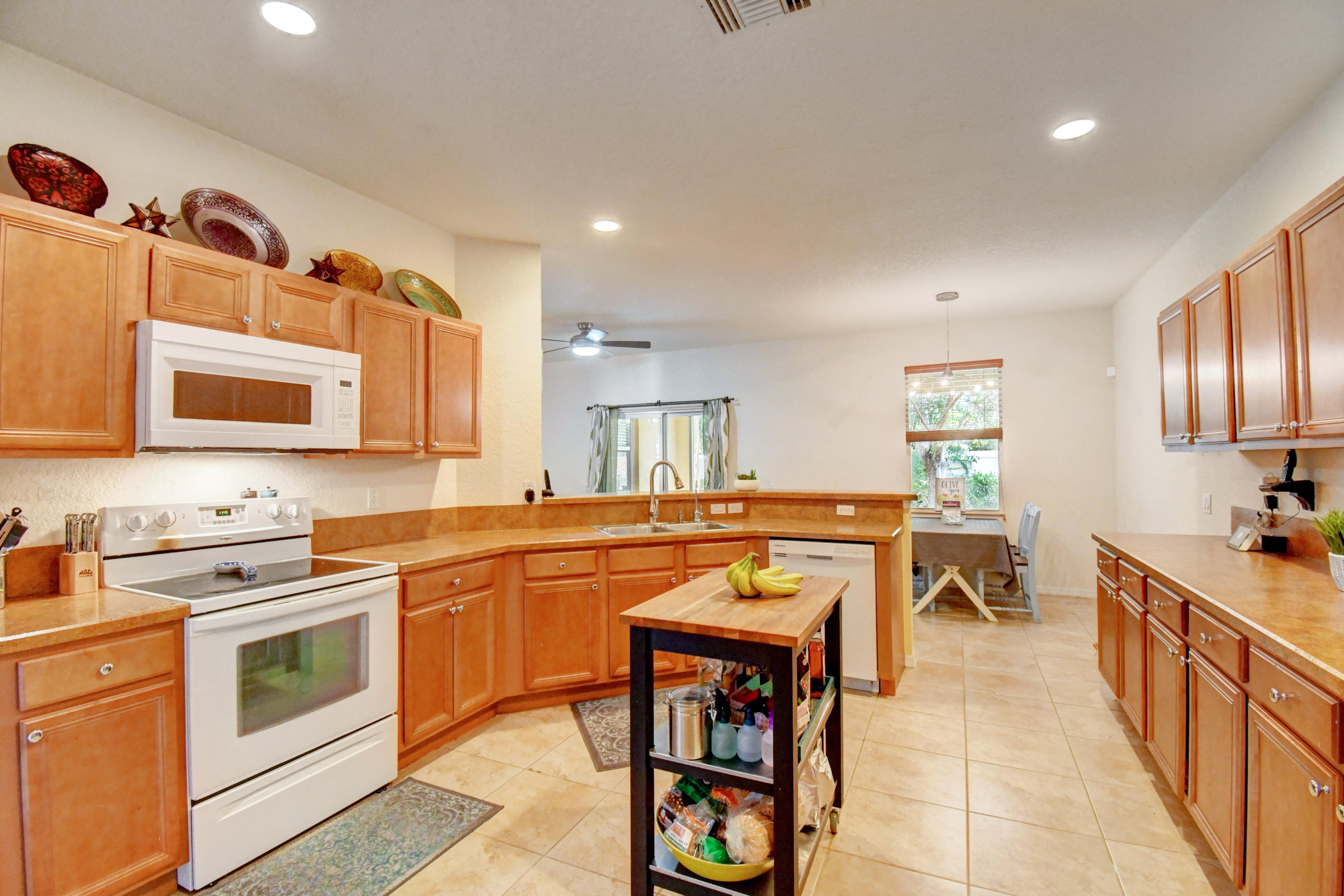 804 Quartz Terrace West Palm Beach, FL 33413 - Photo 19 of 65 a kitchen with stainless steel appliances a stove a sink dishwasher and a refrigerator