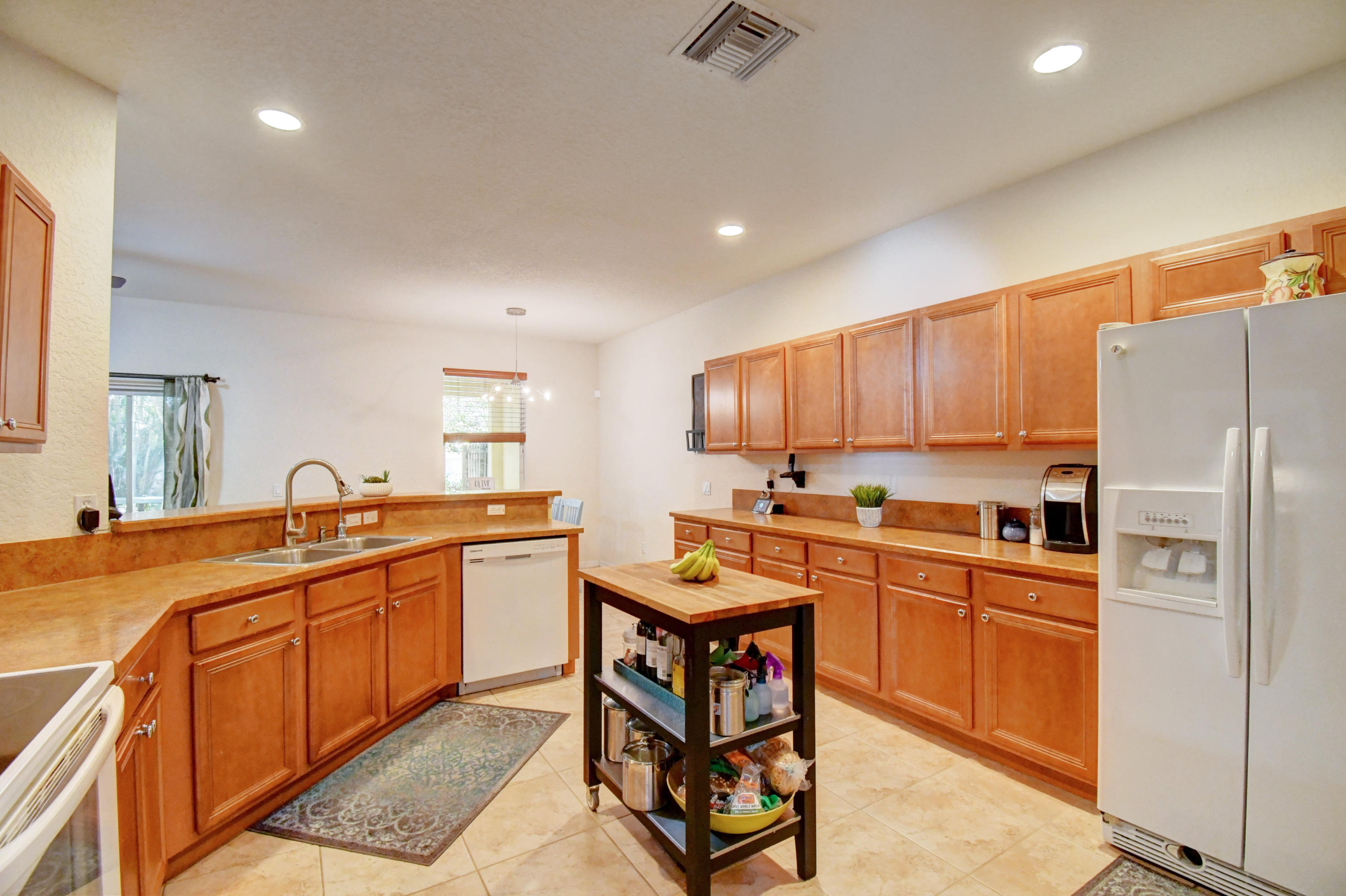 804 Quartz Terrace West Palm Beach, FL 33413 - Photo 20 of 65 a kitchen with stainless steel appliances granite countertop a sink counter space and cabinets