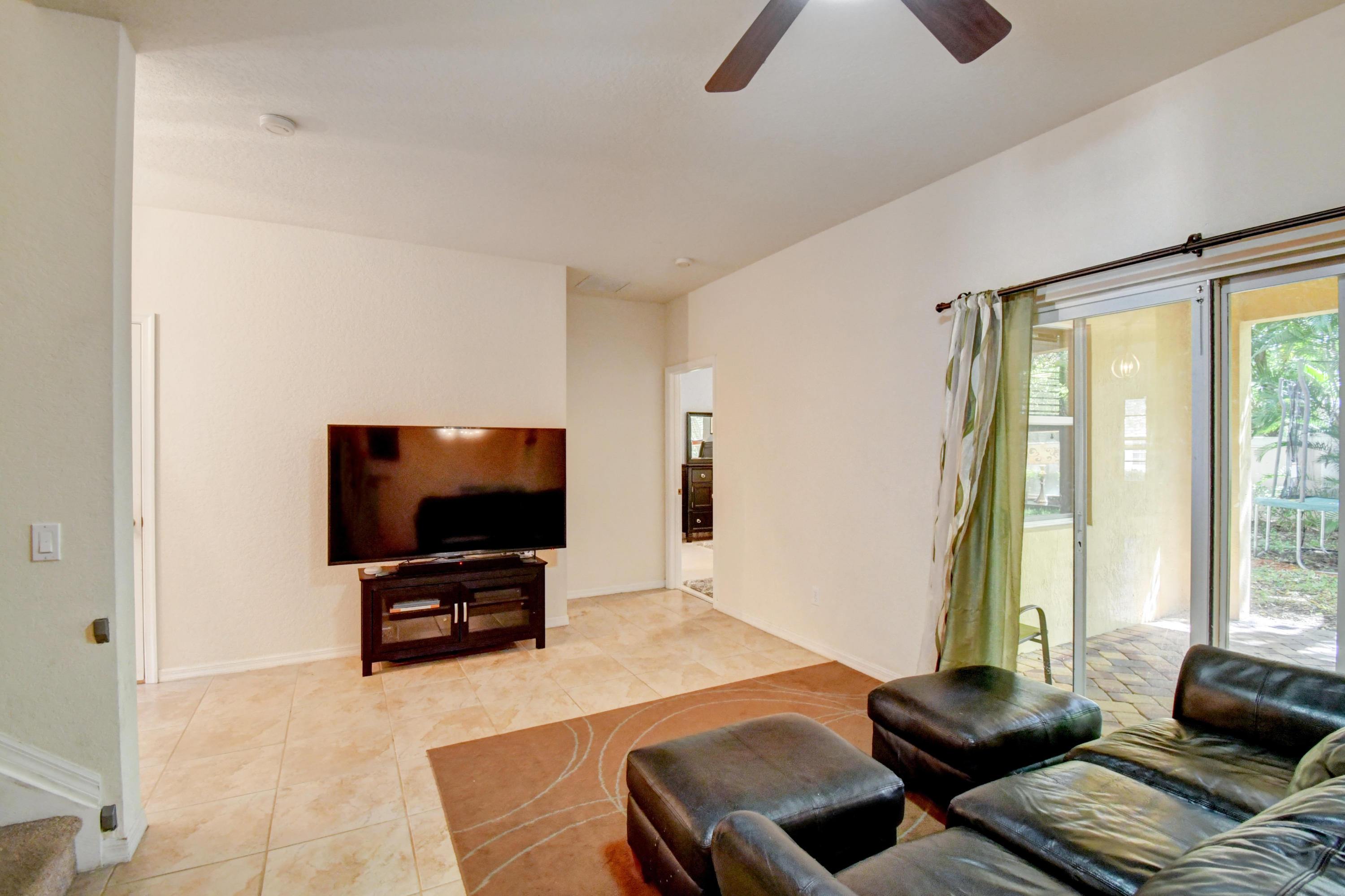804 Quartz Terrace West Palm Beach, FL 33413 - Photo 24 of 65 a living room with furniture and a flat screen tv