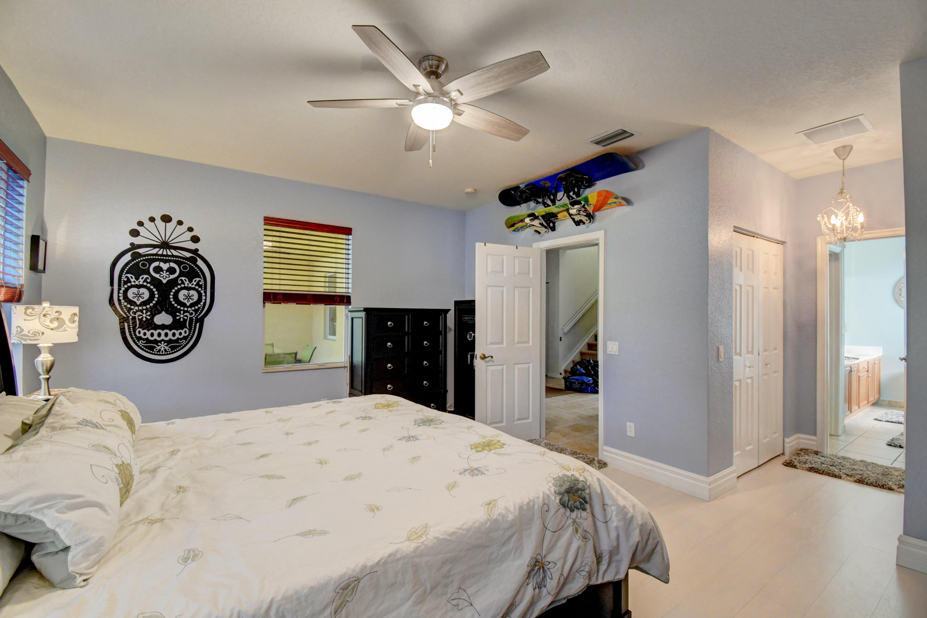 804 Quartz Terrace West Palm Beach, FL 33413 - Photo 28 of 65 a bedroom with a bed and a chandelier