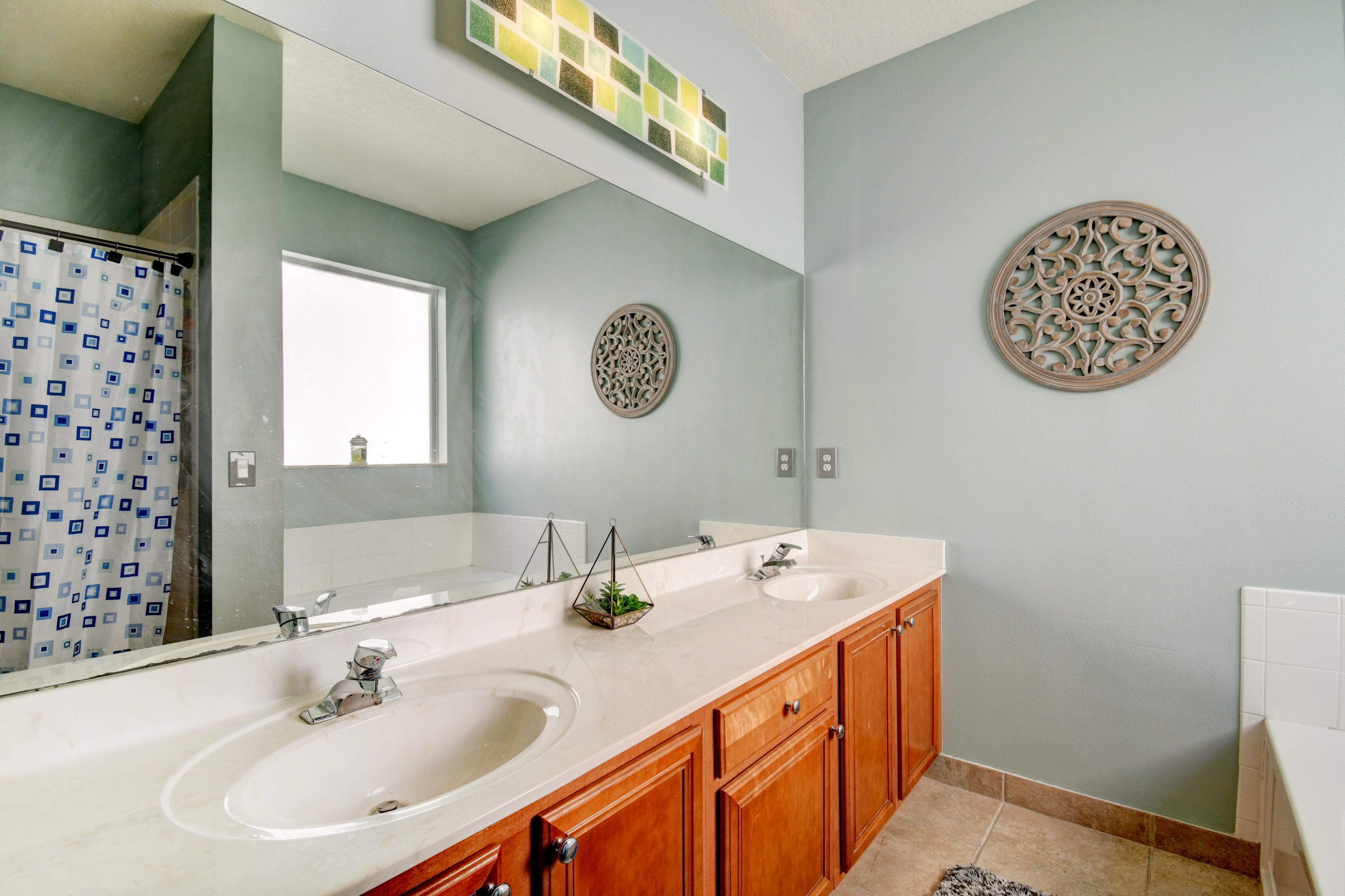804 Quartz Terrace West Palm Beach, FL 33413 - Photo 29 of 65 a bathroom with a sink a mirror and a clock on the wall