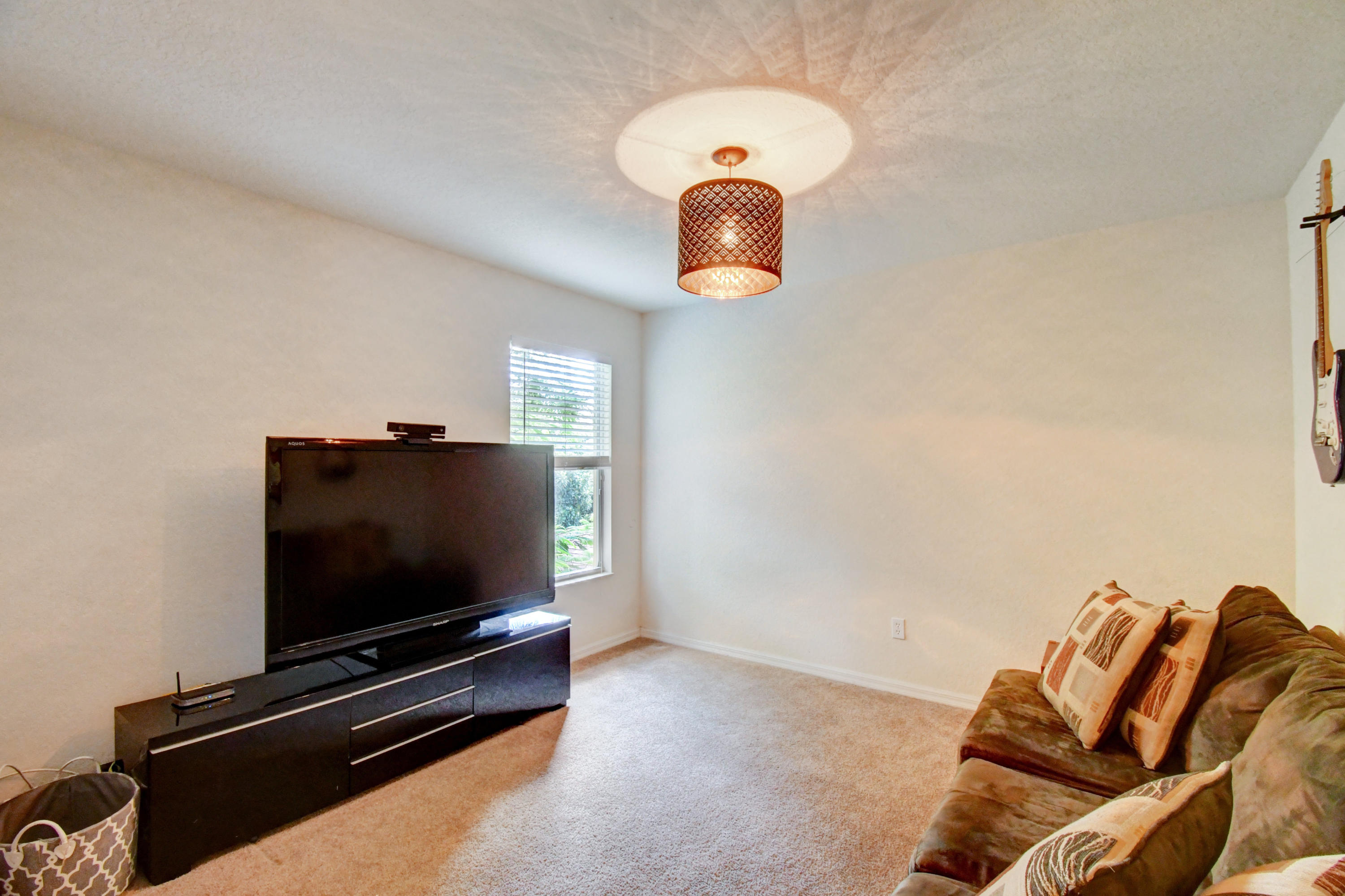 804 Quartz Terrace West Palm Beach, FL 33413 - Photo 33 of 65 a room with furniture and a flat screen tv