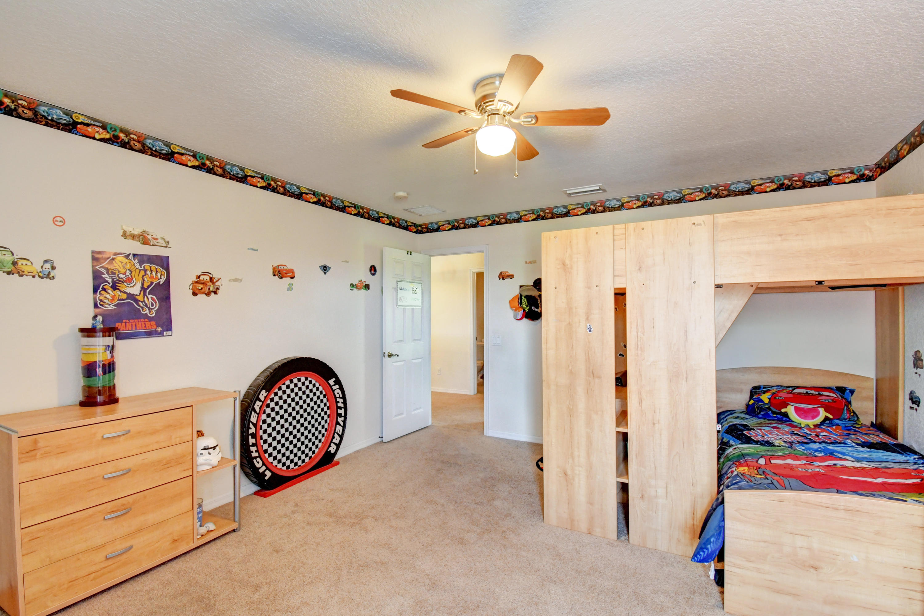 804 Quartz Terrace West Palm Beach, FL 33413 - Photo 37 of 65 a view of a storage & utility room with toys ceiling fan and wooden floor